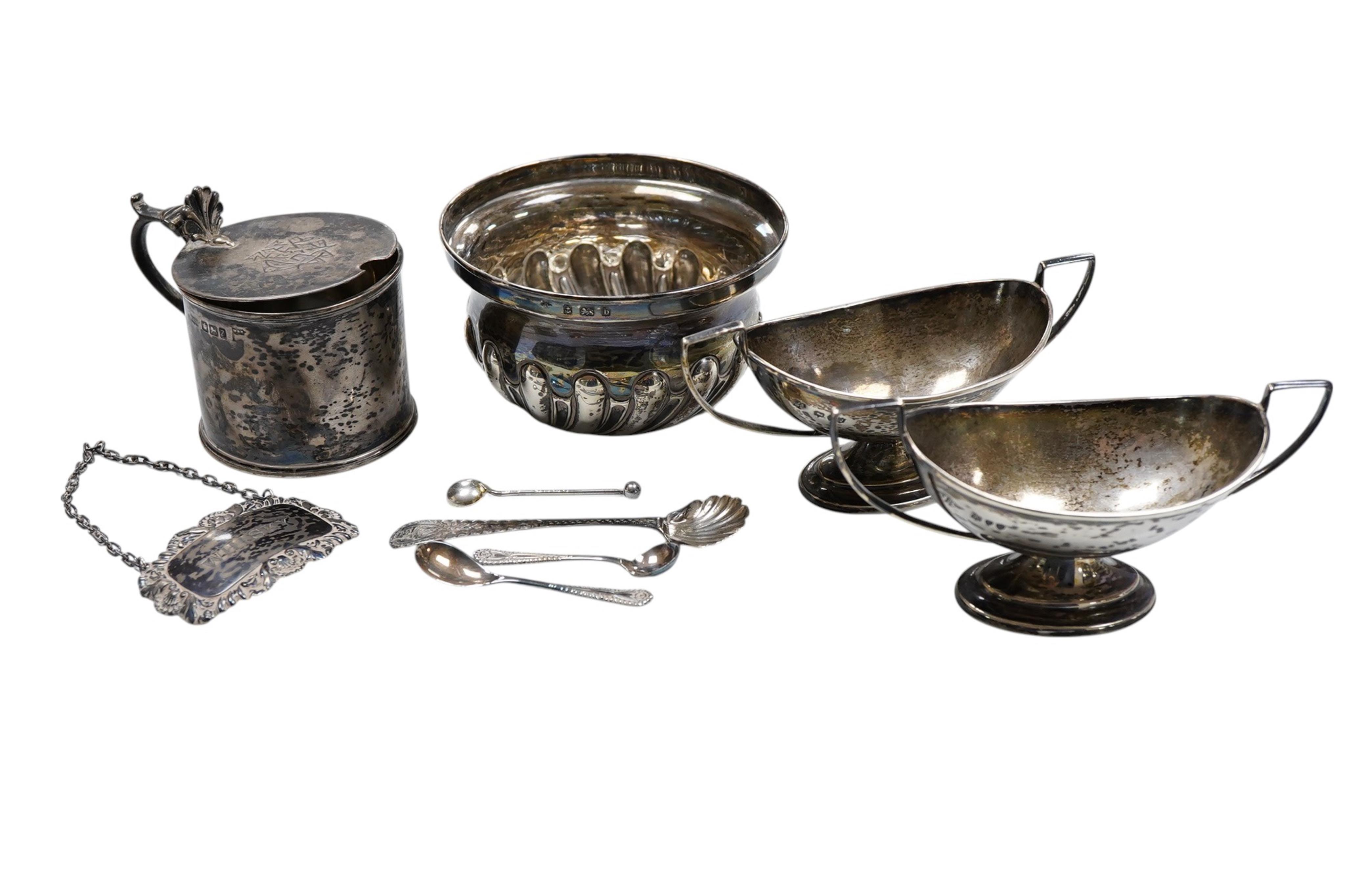An Edwardian silver sugar bowl, by William Hutton & Sons, Birmingham, 1901, diameter 10.1cm, a pair of late Victorian silver two handled boat shaped salts, London, 1891, together with a silver mustard pot, a silver wine